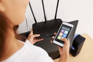woman connecting to wi fi router 2025 01 29 08 18 50 utc